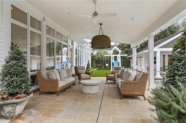 view of patio featuring an outdoor living space, ceiling fan, and a playground