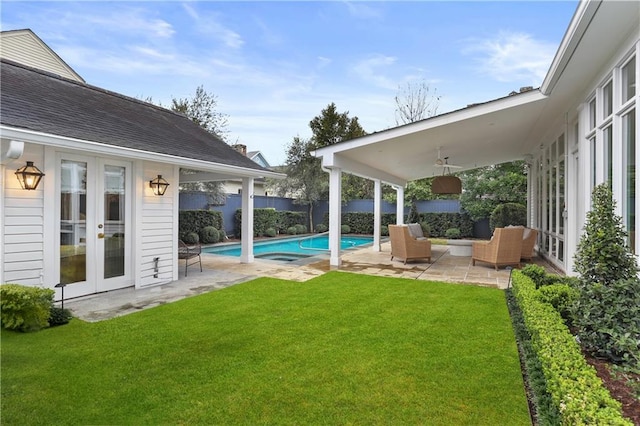 view of yard with a fenced in pool, ceiling fan, outdoor lounge area, a patio area, and french doors