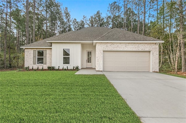 view of front of property featuring driveway, brick siding, an attached garage, and a front yard