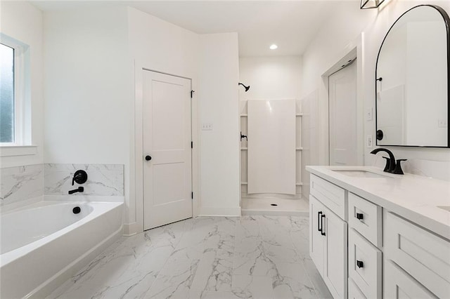 full bath with a sink, recessed lighting, marble finish floor, a bath, and double vanity