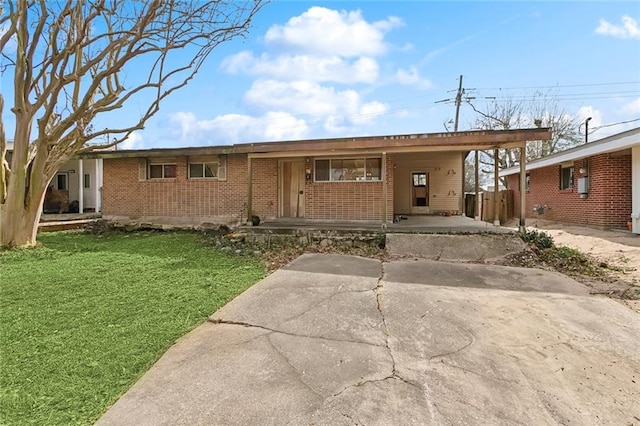 ranch-style house with a front lawn and a carport