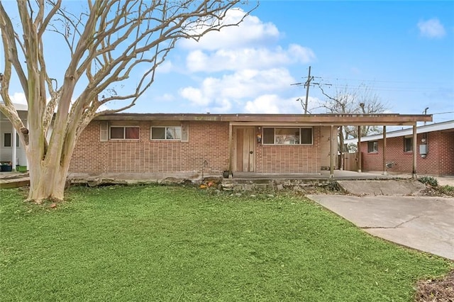 ranch-style home with a carport and a front yard