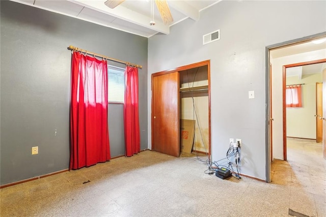 bedroom featuring ceiling fan and beamed ceiling