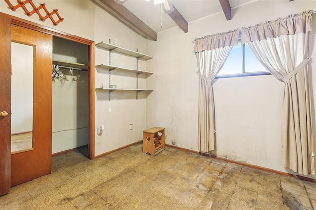 unfurnished bedroom featuring beam ceiling and a closet