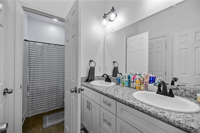 bathroom with wood-type flooring, vanity, and a shower with curtain