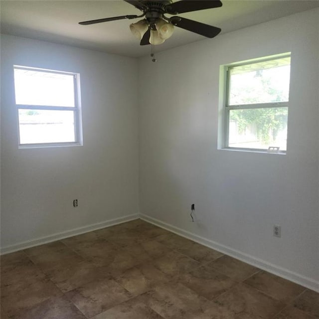 2404 Francis Ave, Violet, LA 70092 - unfurnished room featuring healthy amount of natural light, baseboards, and ceiling fan