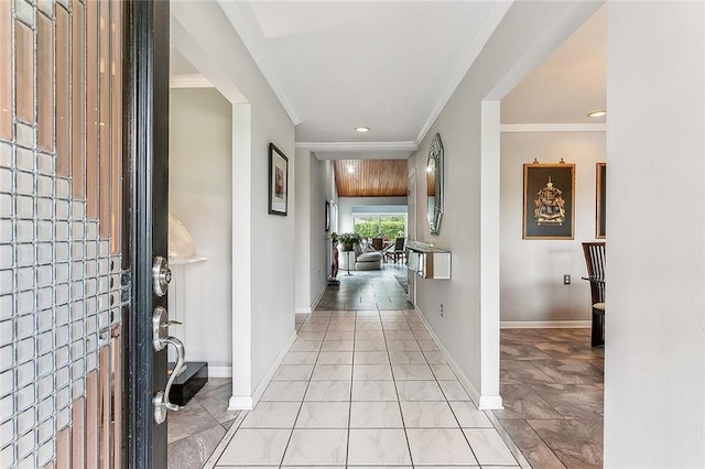 foyer entrance with crown molding, recessed lighting, and baseboards