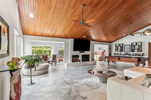 tiled living room featuring lofted ceiling, a ceiling fan, wood ceiling, and a fireplace