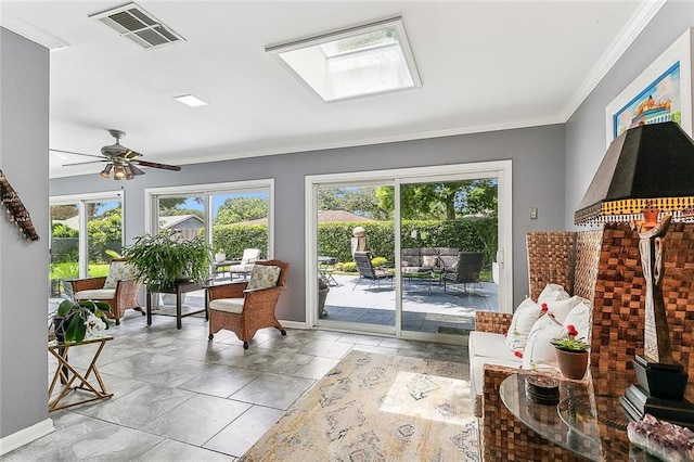 sunroom with a skylight, a ceiling fan, and visible vents