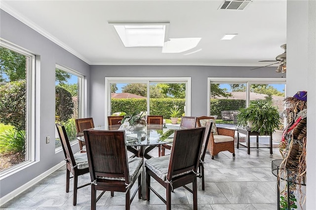 sunroom / solarium featuring a skylight, plenty of natural light, a ceiling fan, and visible vents