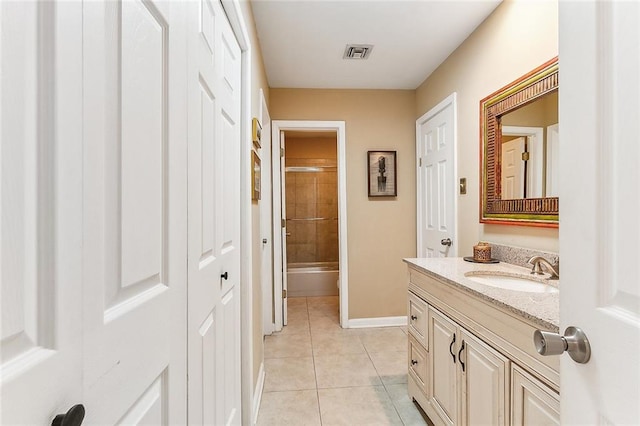 full bathroom with visible vents,  shower combination, tile patterned flooring, baseboards, and vanity