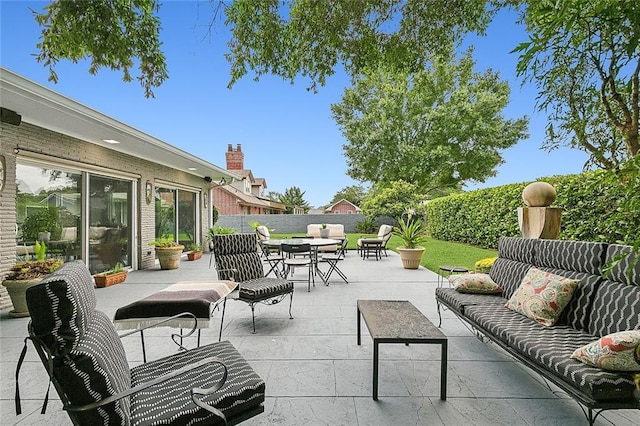 view of patio / terrace with outdoor dining space, an outdoor hangout area, and fence private yard