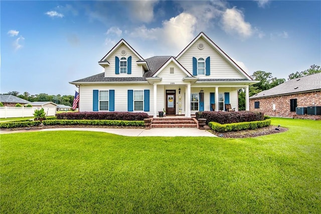 view of front of house featuring central AC and a front yard