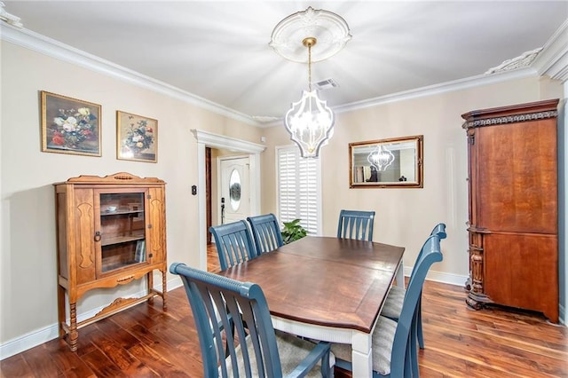 dining space featuring dark wood finished floors, visible vents, crown molding, and baseboards