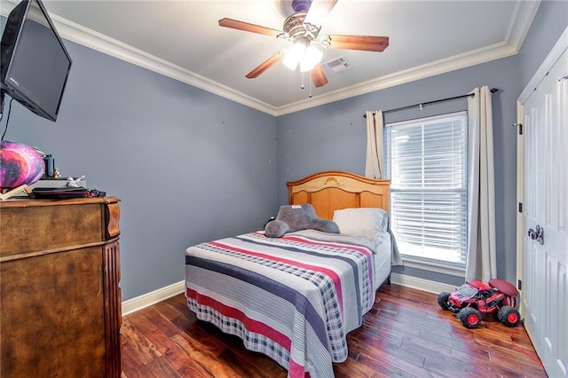 bedroom featuring baseboards, visible vents, a ceiling fan, wood finished floors, and crown molding