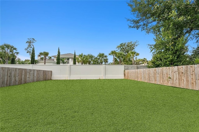 view of yard with a fenced backyard