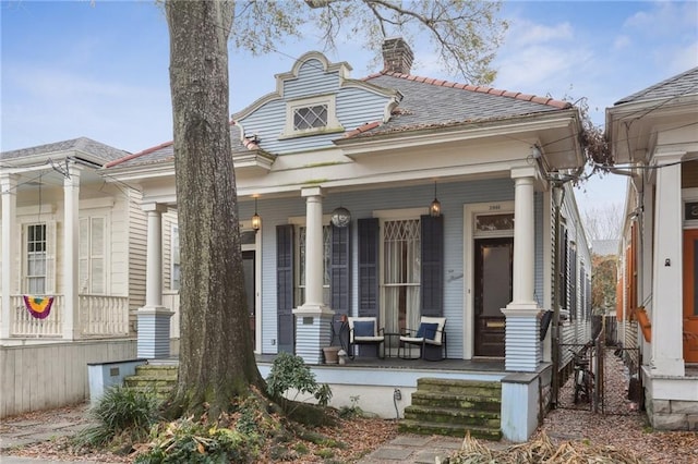 greek revival house with a porch and a chimney