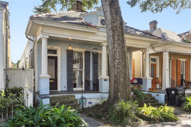 exterior space featuring covered porch and a chimney