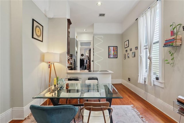 dining space with plenty of natural light and wood-type flooring