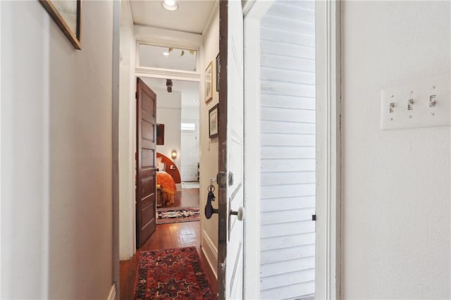 hallway with hardwood / wood-style floors