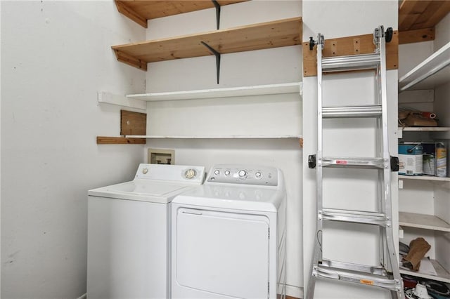 clothes washing area with washing machine and clothes dryer