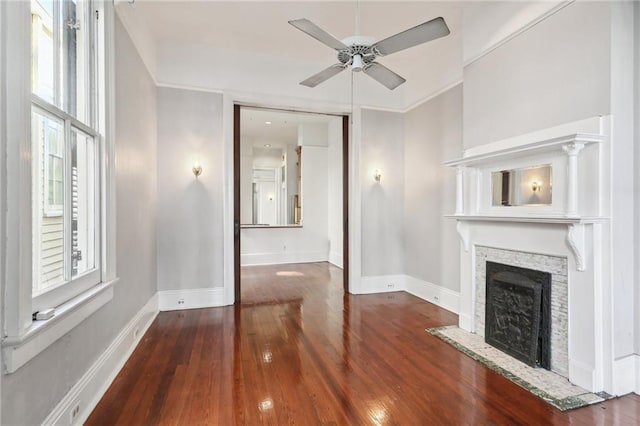 unfurnished living room with dark hardwood / wood-style floors and ceiling fan