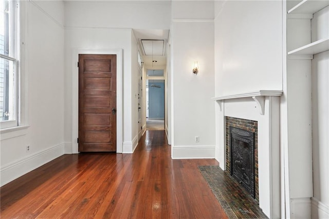 unfurnished living room featuring dark hardwood / wood-style floors and a tile fireplace