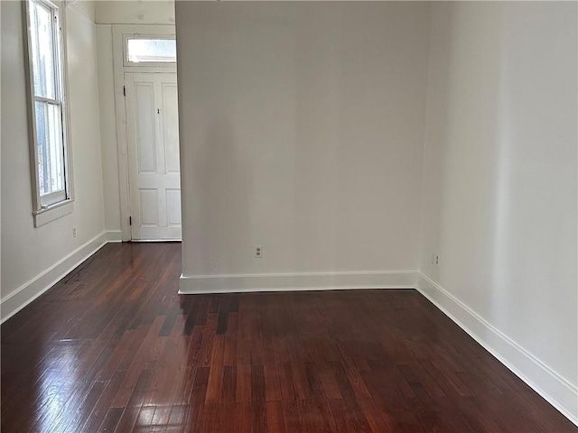 empty room featuring dark wood-type flooring