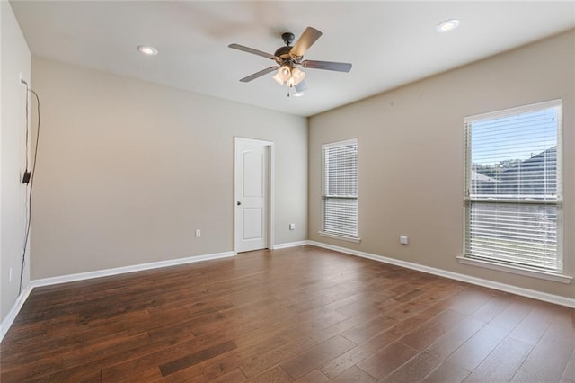 spare room featuring ceiling fan and dark hardwood / wood-style flooring