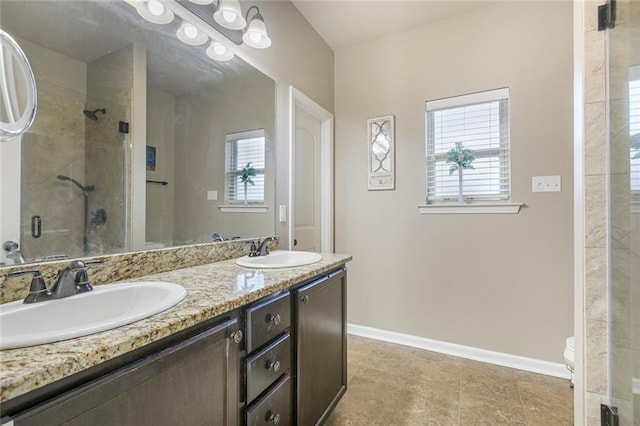 bathroom featuring vanity, plenty of natural light, a shower with door, and toilet