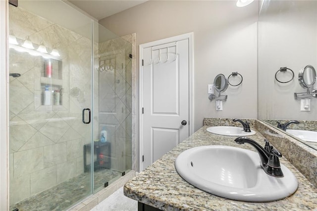 bathroom featuring an enclosed shower and vanity