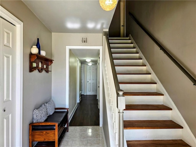 stairs featuring tile patterned floors