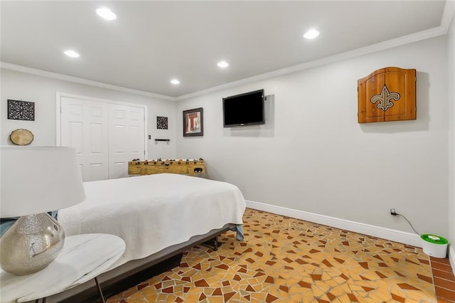 bedroom with crown molding and a closet