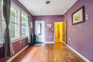 2226 Saint Bernard Ave, New Orleans, LA 70119 - spare room featuring wood finished floors