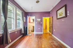 2226 Saint Bernard Ave, New Orleans, LA 70119 - unfurnished bedroom featuring wood finished floors