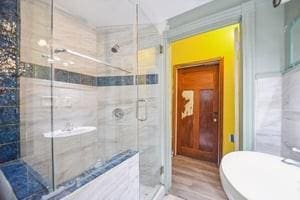2226 Saint Bernard Ave, New Orleans, LA 70119 - full bath with a stall shower and wood finished floors