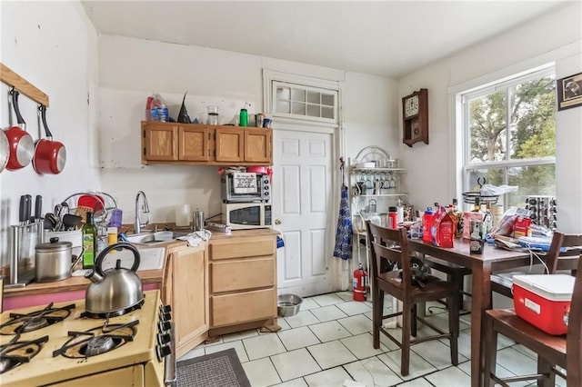 2226 Saint Bernard Ave, New Orleans, LA 70119 - kitchen featuring white appliances, light tile patterned floors, and brown cabinetry