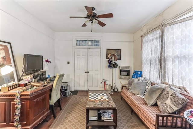 2226 Saint Bernard Ave, New Orleans, LA 70119 - living area featuring heating unit, wood finished floors, a desk, and ceiling fan