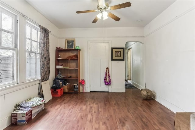2226 Saint Bernard Ave, New Orleans, LA 70119 - empty room with arched walkways, wood finished floors, and a ceiling fan