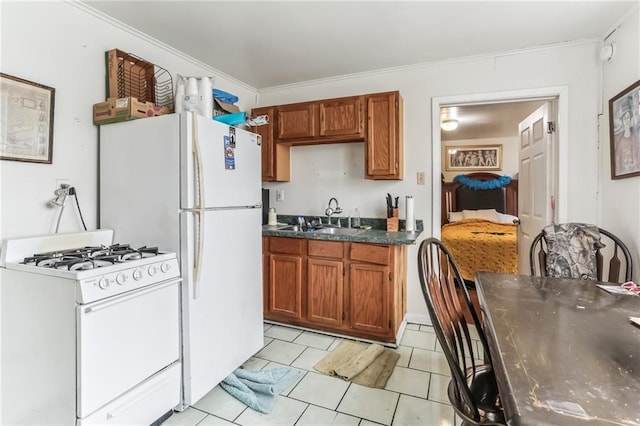 2226 Saint Bernard Ave, New Orleans, LA 70119 - kitchen with white appliances, brown cabinetry, dark countertops, light tile patterned floors, and ornamental molding