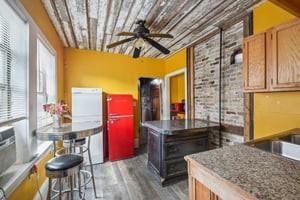 2226 Saint Bernard Ave, New Orleans, LA 70119 - kitchen featuring a ceiling fan and wood finished floors