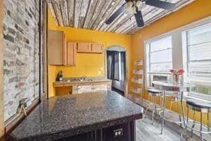 2226 Saint Bernard Ave, New Orleans, LA 70119 - kitchen featuring a ceiling fan and light wood-type flooring