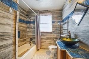 2226 Saint Bernard Ave, New Orleans, LA 70119 - bathroom featuring vanity, bathtub / shower combination, and tile patterned flooring