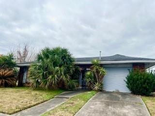 view of front of house featuring a garage and a front lawn