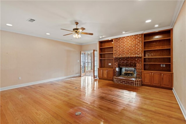 unfurnished living room with crown molding, a fireplace, and light hardwood / wood-style floors