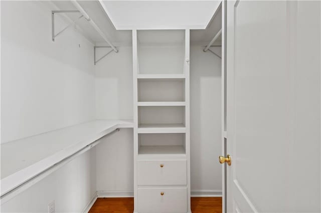 walk in closet featuring dark wood-type flooring