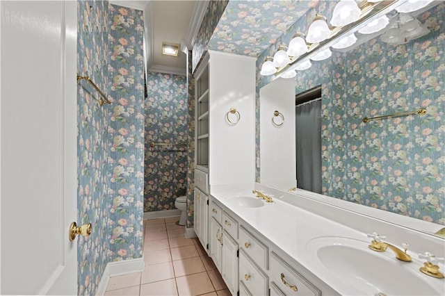 bathroom featuring vanity, tile patterned floors, crown molding, and toilet