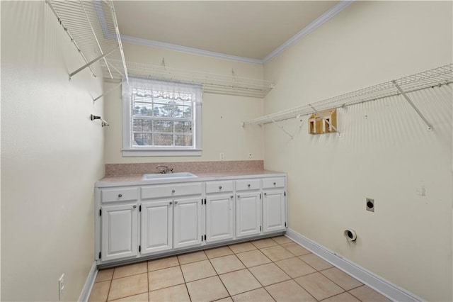 clothes washing area featuring light tile patterned flooring, sink, cabinets, ornamental molding, and hookup for an electric dryer