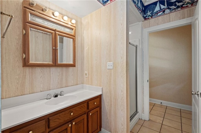 bathroom featuring tile patterned flooring, vanity, and walk in shower