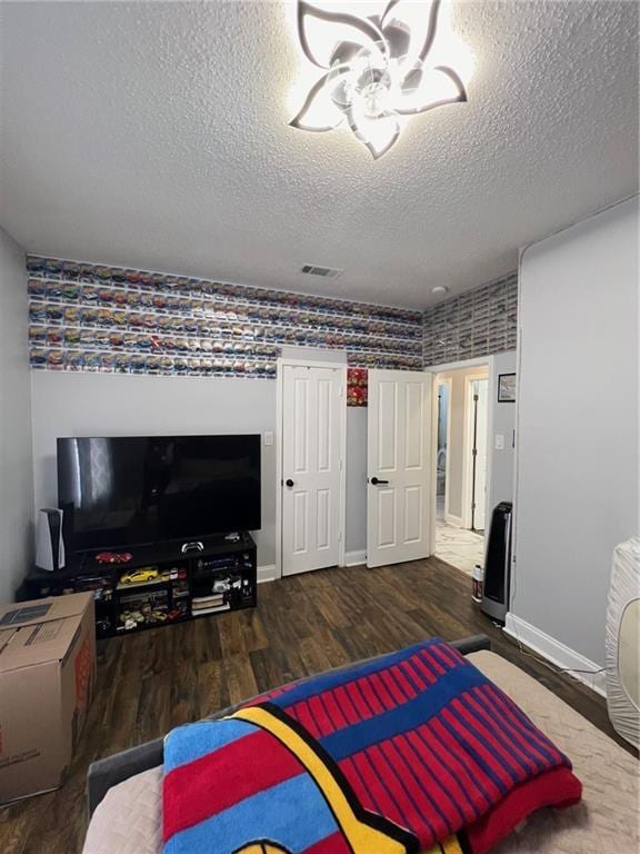 bedroom featuring dark hardwood / wood-style floors and a textured ceiling